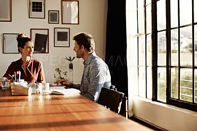 Buy stock photo Shot of a couple working at their dining table