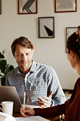 Buy stock photo Shot of a couple working at their dining table