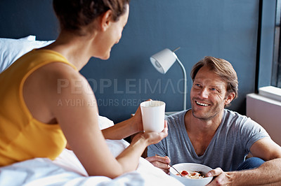 Buy stock photo Shot of a mature couple having breakfast in their bedroom