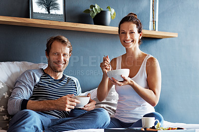 Buy stock photo Portrait of a content couple having breakfast in their bedroom