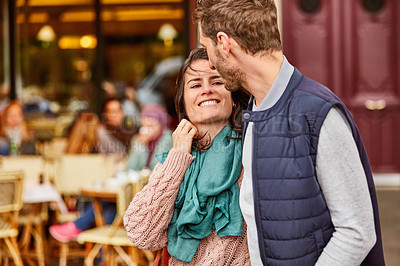 Buy stock photo Shot of a young couple enjoying the day together walking through the the city