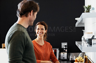 Buy stock photo Shot of a smiling mature couple cooking together in their kitchen