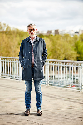 Buy stock photo Portrait of a handsome mature man standing on a bridge