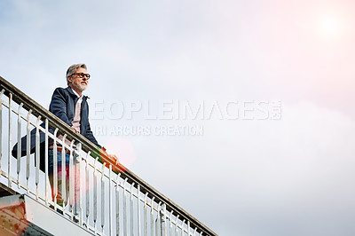 Buy stock photo Shot of a mature man admiring the view while leaning on the railing of a bridge