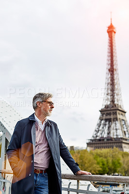 Buy stock photo Shot of a handsome mature man with the Eiffel Tower in the background