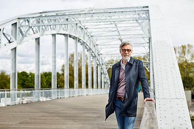 Buy stock photo Portrait of a mature man leaning on the railing of a bridge