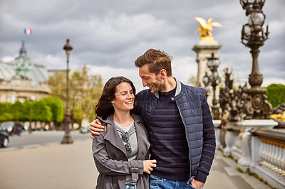 Buy stock photo Shot of a smiling young couple walking together in the streets of Paris