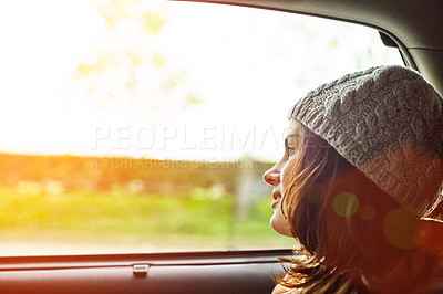 Buy stock photo Shot of a young woman looking through a car window while driving in Paris