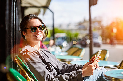 Buy stock photo Portrait of a smiling young woman sitting at a sidewalk cafe in Paris using a digital tablet
