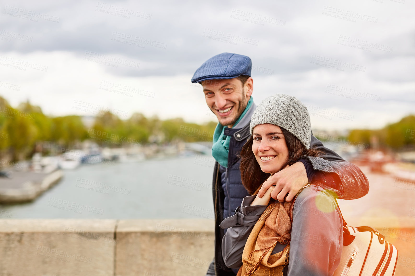 Buy stock photo Portrait, couple and walk in city with tourist holiday, relationship and smile for sightseeing trip. Happy people, dating and outdoor on bridge with river, vacation and quality time with companion.
