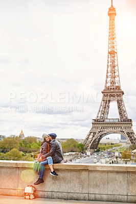 Buy stock photo Shot of a happy young couple sitting together in front of the Eiffel Tower
