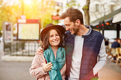 Buy stock photo Shot of a smiling young couple walking together in the streets of Paris