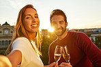 Enjoying wine and a city sunset
