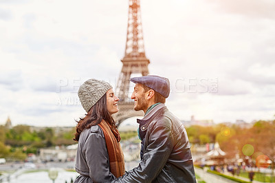 Buy stock photo Shot of a happy young couple kissing together in front of the Eiffel Tower