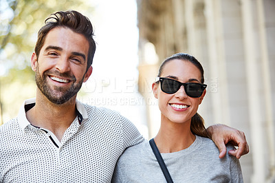 Buy stock photo Portrait of an affectionate young couple standing together in the city