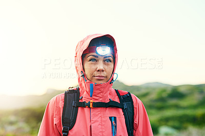 Buy stock photo Shot of a focused young woman out for a run on a cool morning