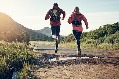 Buy stock photo Rearview shot of two friends out for a run together on a cool morning