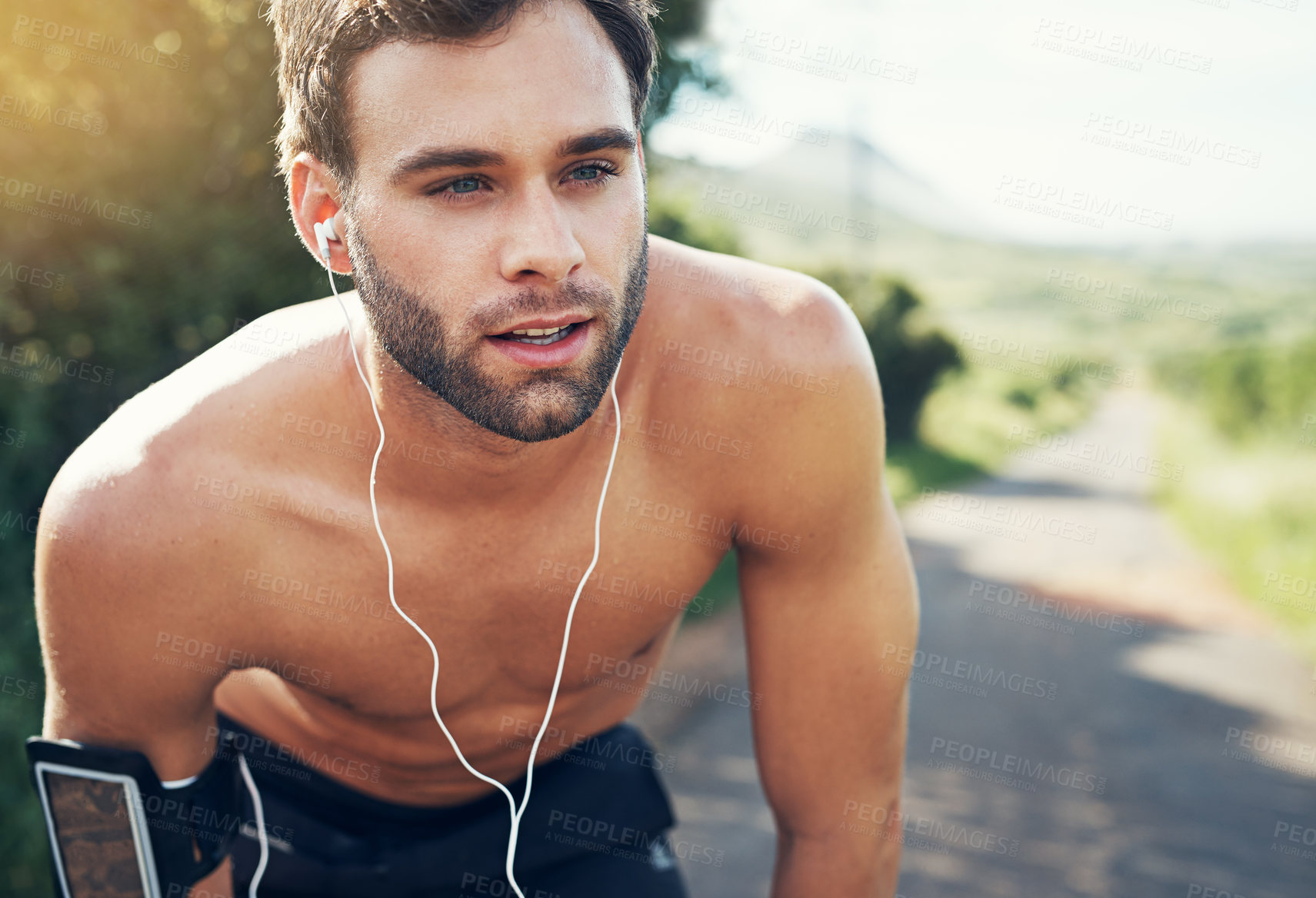 Buy stock photo Workout, breathing and man with earphones in park for fitness break, cardio and endurance. Runner, thinking and tired in nature for exercise music, rest and wellness podcast for morning performance