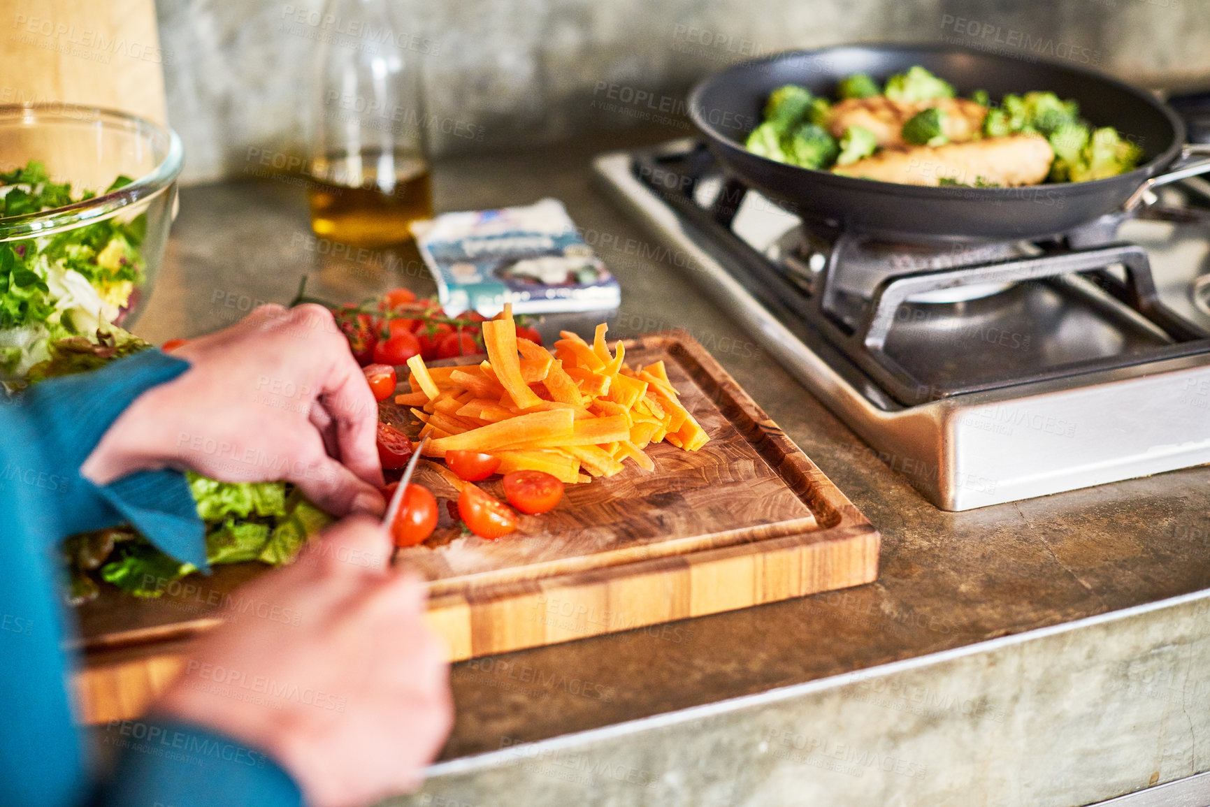 Buy stock photo Closeup shot of a woman chopping vegetables on her kitchen counter