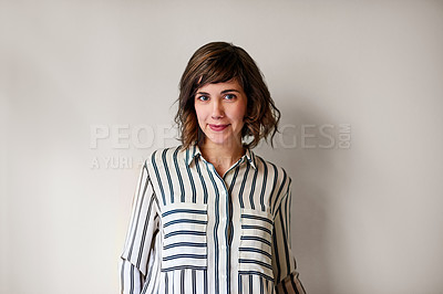 Buy stock photo Portrait of an attractive young woman standing against a gray background