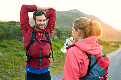 Buy stock photo Shot of two friends stretching before a run on a cool morning