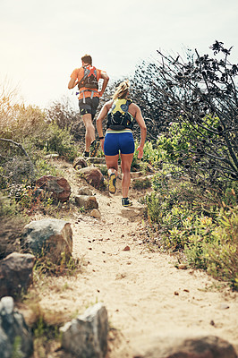 Buy stock photo Shot of two friends out for a run together on a cool morning