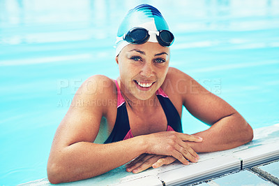Buy stock photo Portrait of an athletic young woman in swimming goggles leaning on the edge of a swimming pool