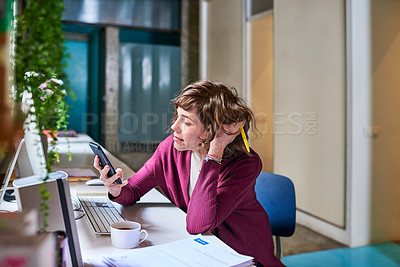Buy stock photo Shot of an attractive young businesswoman working in her office