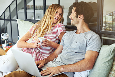 Buy stock photo Shot of an affectionate young couple relaxing on the sofa at home