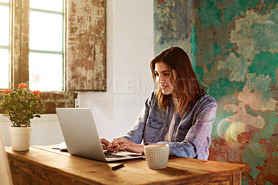 Buy stock photo Shot of a young woman working on her laptop at a desk in her room