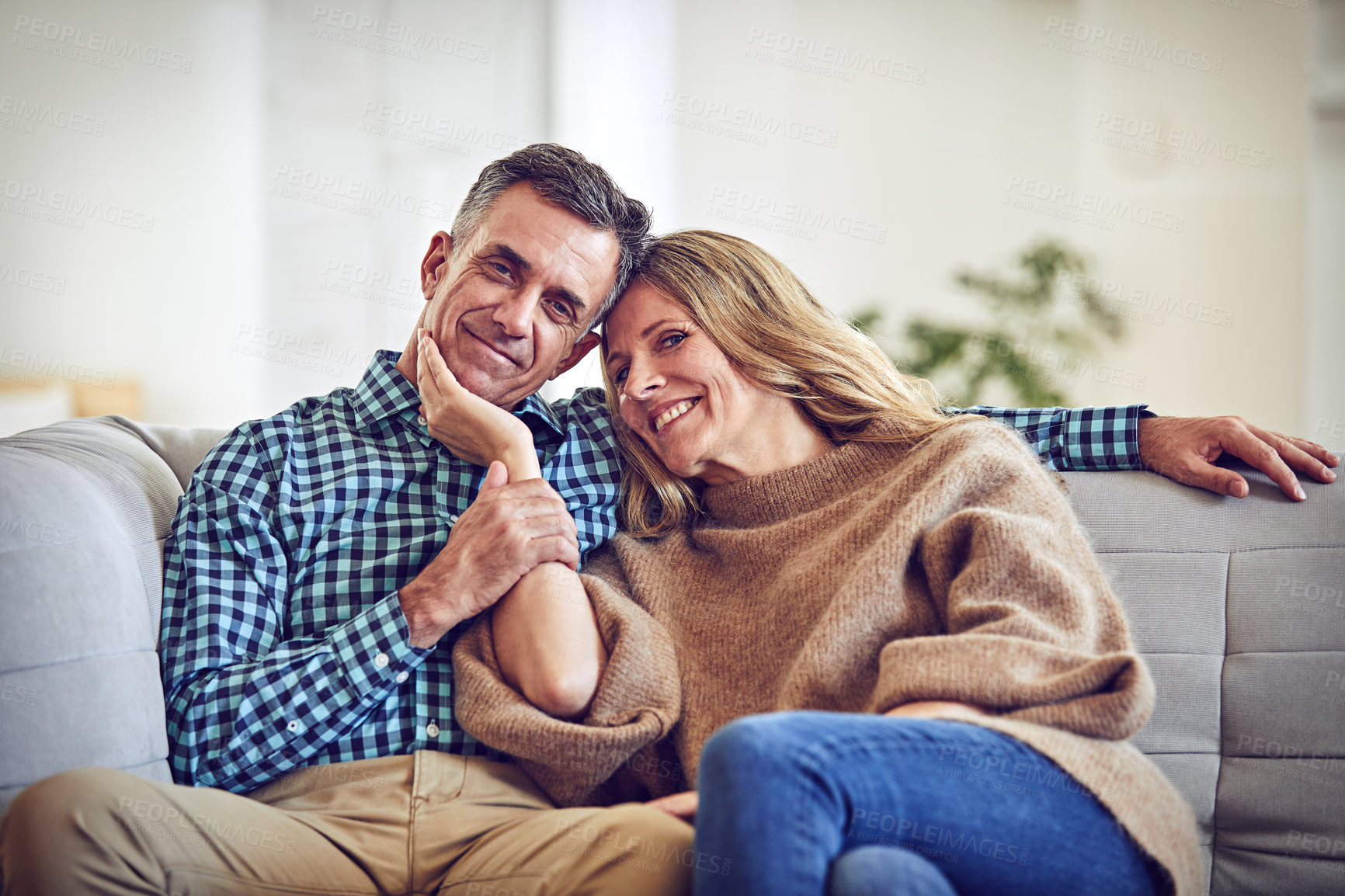 Buy stock photo Smile, relax and love with couple on sofa in home for connection, portrait and support together. Marriage commitment, happiness and loyalty with mature man and woman in living room in house for trust