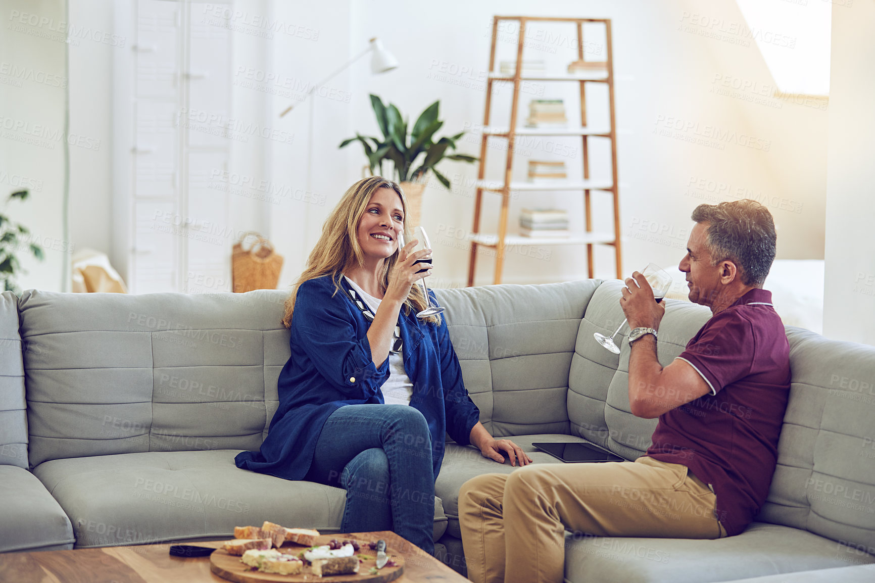 Buy stock photo Relax, wine and love with couple on sofa for cheese tasting, bonding and marriage connection. Happy, alcohol drink and date with mature man and woman in living room in house for smile and support