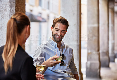 Buy stock photo Shot of a couple having wine outside at a restaurant