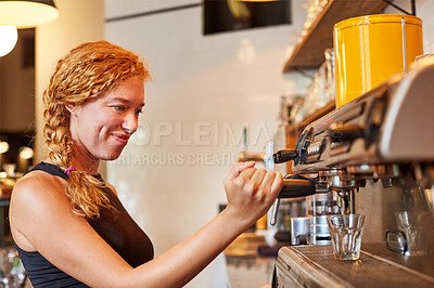 Buy stock photo Shot of a barista on duty in a coffee shot