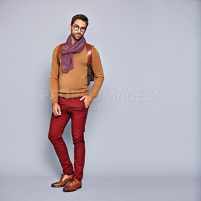 Buy stock photo Studio portrait of a handsome young man posing against a gray background