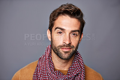 Buy stock photo Studio portrait of a handsome young man posing against a gray background