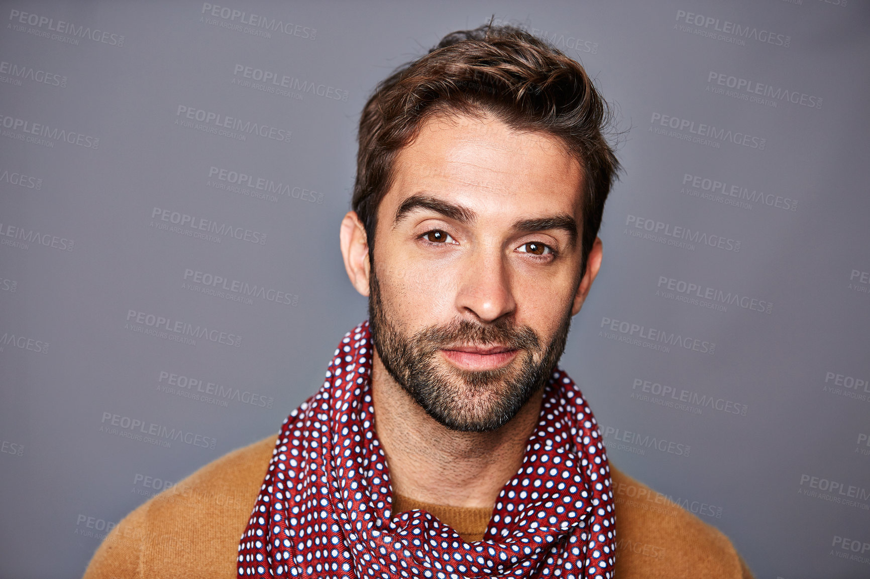 Buy stock photo Studio portrait of a handsome young man posing against a gray background