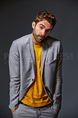 Buy stock photo Studio portrait of a handsome young man shrugging his shoulders against a gray background