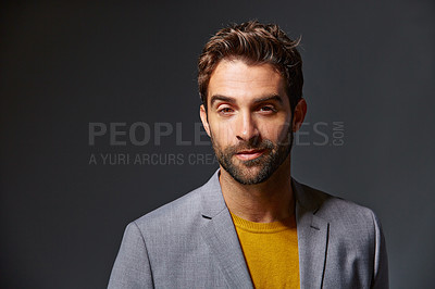Buy stock photo Studio portrait of a handsome young man posing against a gray background