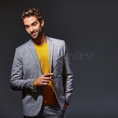 Buy stock photo Studio portrait of a handsome young man posing against a gray background
