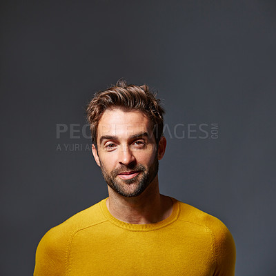 Buy stock photo Studio portrait of a handsome young man posing against a gray background