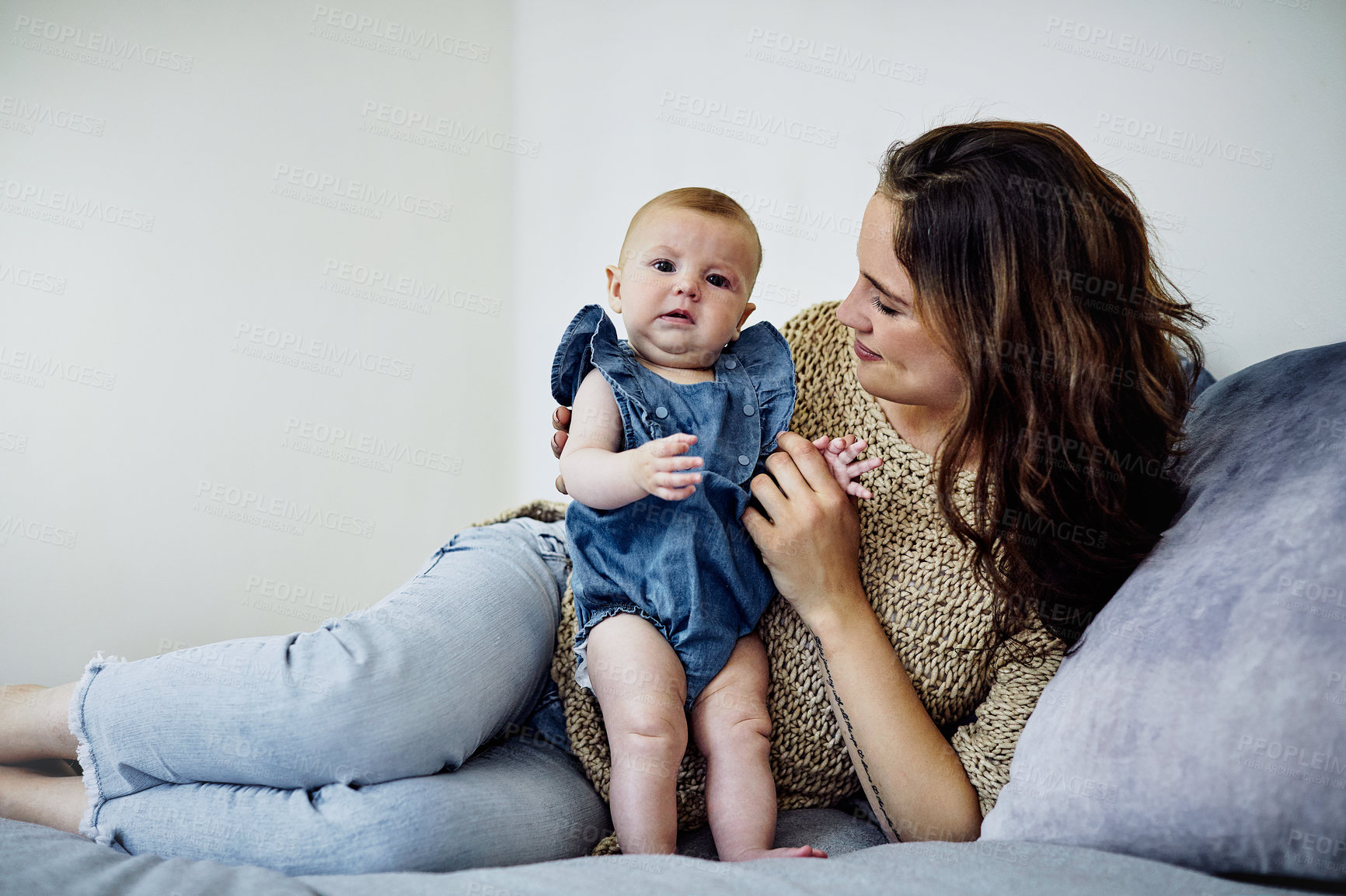 Buy stock photo Shot of an attractive young woman spending time with her newborn daughter