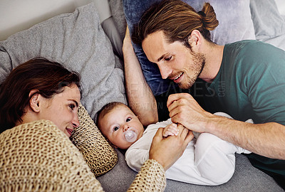 Buy stock photo High angle shot of an affectionate young couple spending time with their newborn daughter
