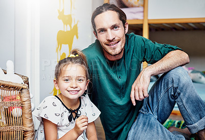 Buy stock photo Portrait of a handsome young father and his daughter bonding at home