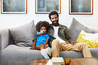 Buy stock photo Portrait of a cheerful young father and son relaxing on a couch while watching television at home