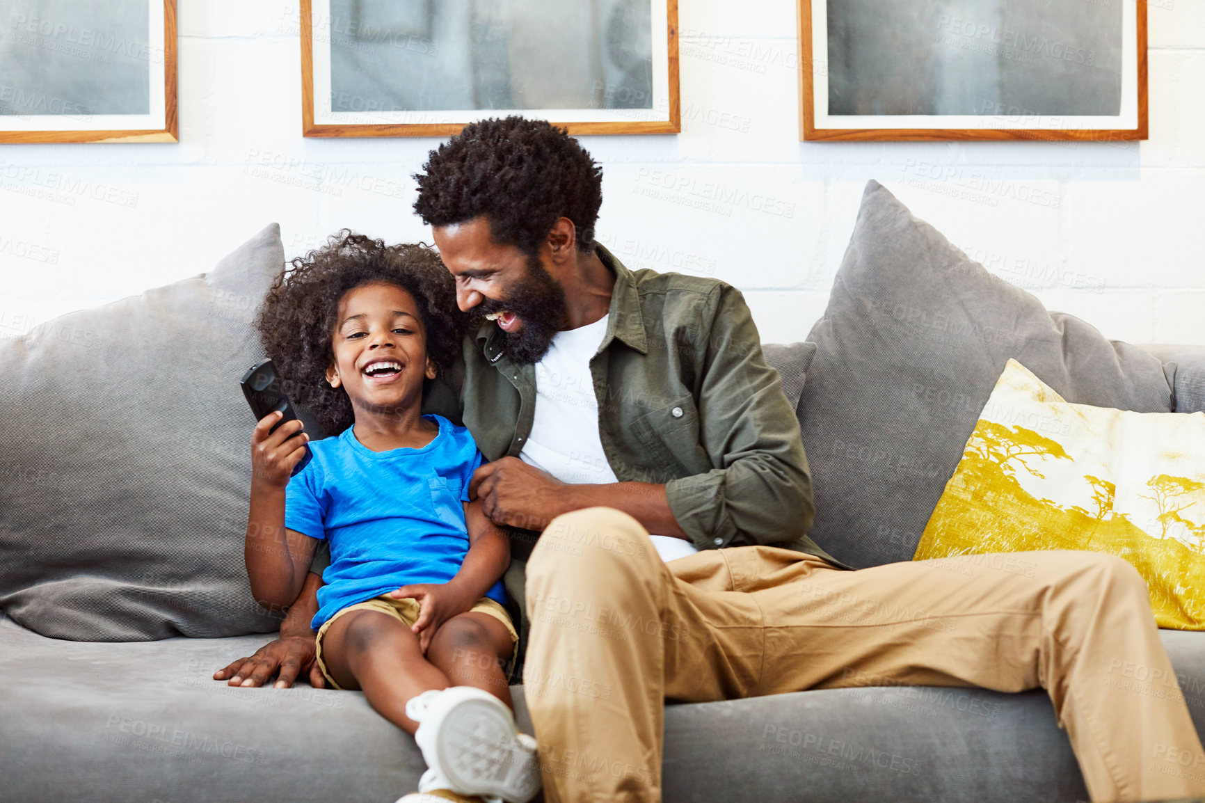 Buy stock photo Dad, child and laugh or watching tv in home living room with comedy movie, happy and cartoon show. Black family, man and son in house for bonding, entertainment and streaming online subscription