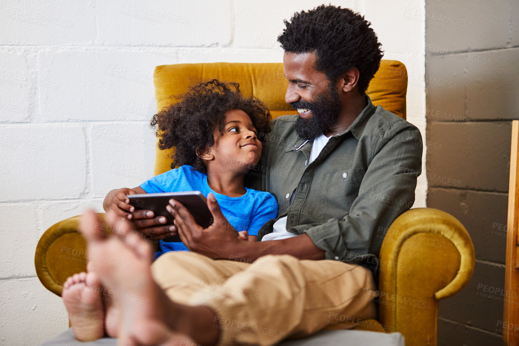 Buy stock photo Father, child and communication with tablet in family home with bonding, elearning and connection. Black man, son and together in house for tech, speech development and kids video on education app