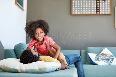 Buy stock photo Portrait of a cheerful little boy being held by his dad while lying down on a couch