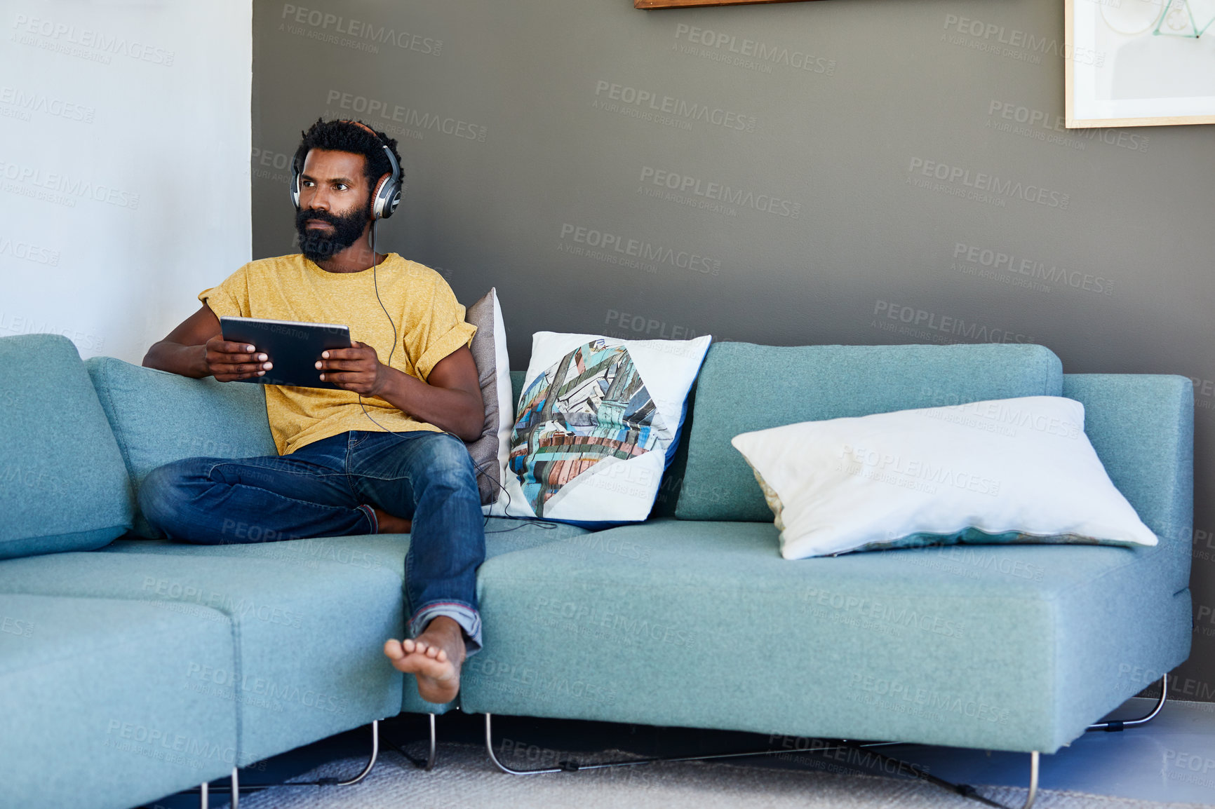 Buy stock photo Streaming, tablet or black man on couch with headphones, song reflection or movie binge on day off. Thinking, space or person in house with tech, music perspective or watching show on weekend break.