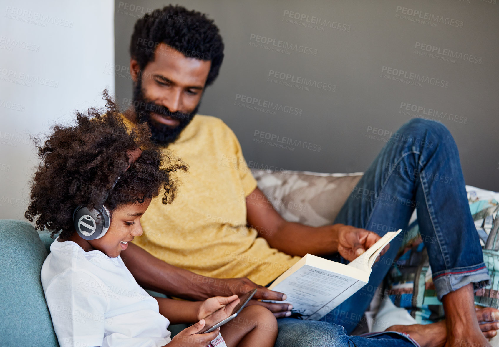 Buy stock photo Book, break and tablet of son with father on living room sofa together for online gaming or reading. Literature, relax and video game with black family in apartment for hobbies or weekend bonding